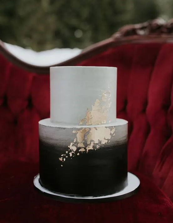 a brushed ombre black and white wedding cake with gold leaf decor for a bold wedding with a classic color scheme