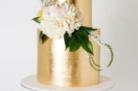 a chic gold leaf wedding cake with greenery and neutral blooms looks elegant and very bold