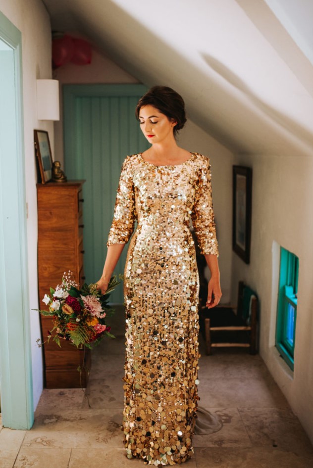 a fantastic gold sequin wedding dress with shot sleeves and a train is a beautiful idea for a glam bride, looks bold and cool