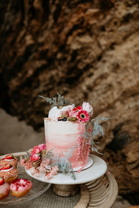 a lovely ombre pink wedding cake with a raw edge, white and pink blooms and greenery is a fantastic idea for a spring or summer wedding
