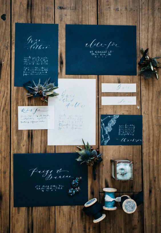 a midnight blue and white wedding invitation suite with calligraphy and lace touches looks very elegant