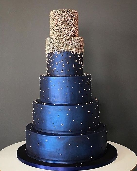 a midnight blue wedding cake decorated with sparkling edible beads looks very bold and statement like