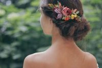 a pretty twisted low updo with bright fall blooms and leaves usd as a hairpiece is a lovely idea for the fall