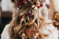 a relaxed boho half updo with some hair up and locks down, with bold fresh and dried blooms tucked in is a lovely idea for the fall