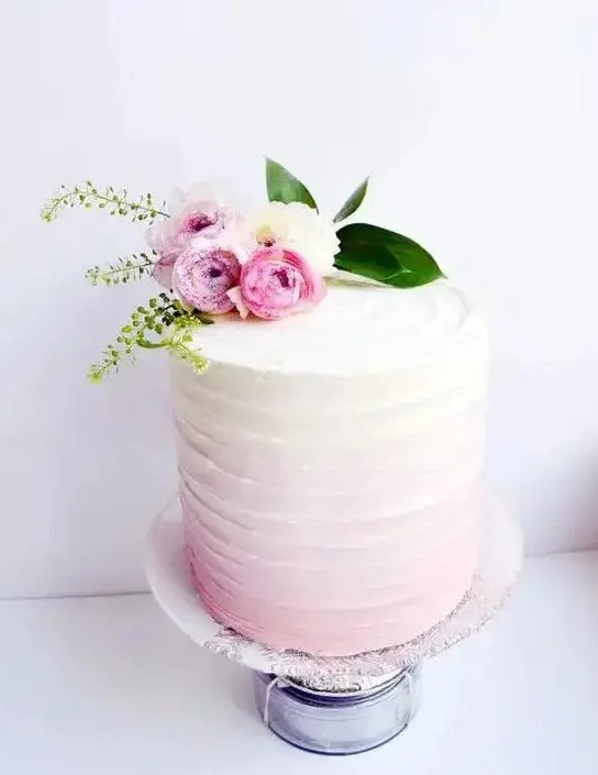a soft ombre pink wedding cake with a texture and baby roses on top will perfectly fit a spring or summer wedding