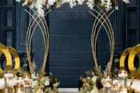 a sophisticated gold and white wedding ceremony space with a gold altar with white blooms, white and gold chairs and pillar candles in glasses