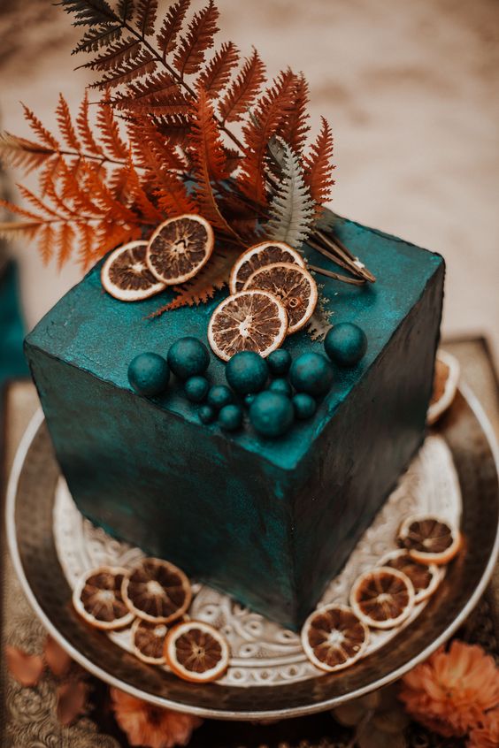 a statement black square wedding cake with sugar beads, dried citrus, dried ferns for a Halloween wedding