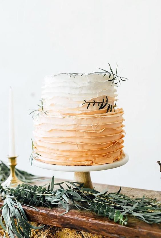 an ombre ruffle wedding cake from white to peachy, with a bit of greenery is a lovely idea for a spring or summer wedding
