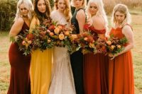 colorful and mismatching maxi bridesmaid dresses in burgundy, orange, rust, mustard and dark green for a fall wedding