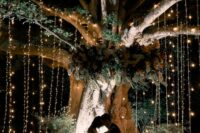 a lovely glowing living tree backdrop for a wedding ceremony