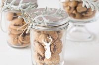 jars with chocolate chip cookies decorated with deer silhouettes and with pale greenery are fantastic for a fall or winter wedding