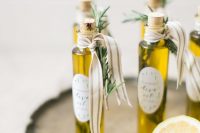 olive oil in small and tall bottles, with ribbons and herbs attached is a great idea for any kind of wedding, from a fall to a summer one