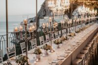 refined candelabras and chic chandeliers are a great combo to illuminate a chic and sophisticated wedding reception space