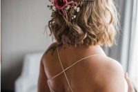 wavy half updo with pink and white blooms and some greenery is a beautiful solution for a bride with medium length hair