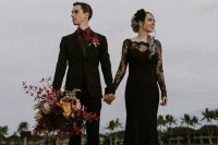 a black lace sheath wedding dress with an illusion neckline and long sleeves plus a fabric bloom headpiece for a Halloween wedding