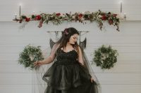 a black strapless wedding ballgown with an embellished bodice and a long veil for a Halloween bride