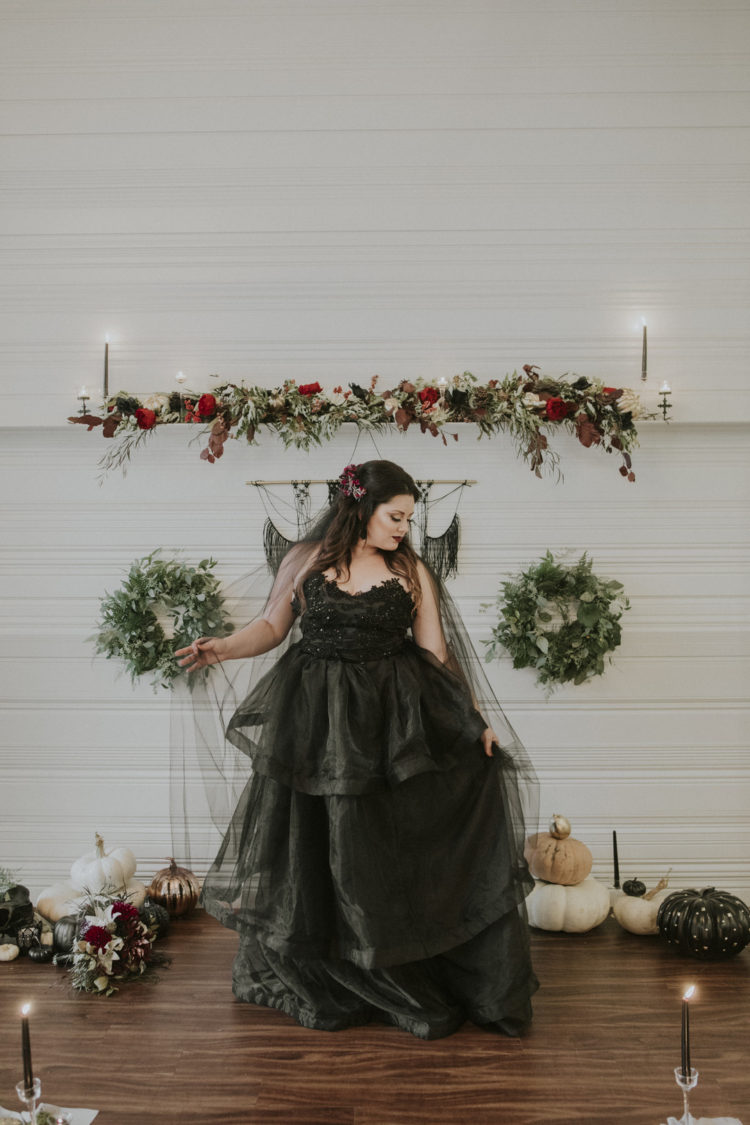 a black strapless wedding ballgown with an embellished bodice and a long veil for a Halloween bride