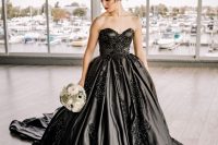 a black strapless wedidng ballgown with an embroidered lace applique bodice and a train is very refined and chic
