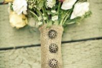 a burlap wrap with beautiful decorative buttons is a pretty accessory for a rustic wedding bouquet