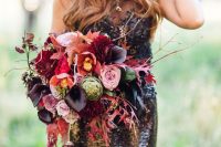 a colorful Halloween wedding bouquet with pink, lavender, red, burgundy flowers, twigs, fall leaves and cascading touches