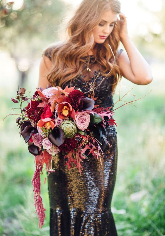 a colorful Halloween wedding bouquet with pink, lavender, red, burgundy flowers, twigs, fall leaves and cascading touches