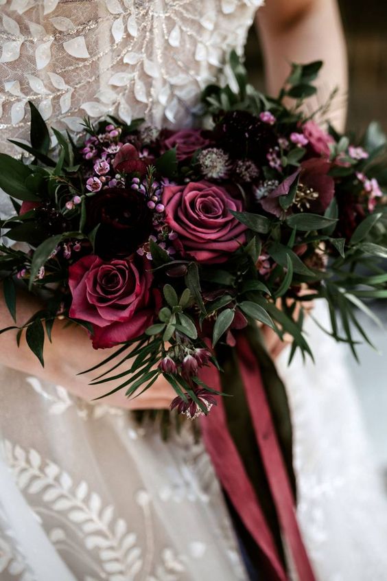 a deep purple and burgundy wedding bouquet with some greenery is an elegant monochromatic piece for a Halloween bride