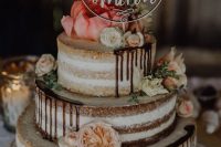 a delicious three-tier naked wedding cake with chocolate drip, neutral and pastel blooms and a mountain topper