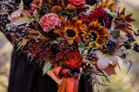 a fabulous Halloween wedding bouquet with red, pink, orange and mustard blooms, berries and fall leaves