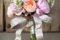 a glitter ribbon wrap with a large bow and long ribbons is a timeless idea for a glam wedding