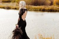 a gorgeous black lace mermaid wedding dress with an open back and a tail is very refined and chic