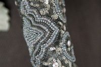 a grey embellished bouquet wrap with sequins and rhinestones is a very chic and bold idea