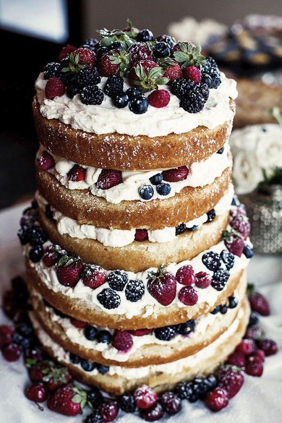 a jaw dropping naked wedding cake with frosting and fresh berries is a fantastic idea for a summer wedding