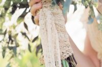a lace bouquet wrap with long ribbons is a chic and cute idea for a rustic or vintage bride