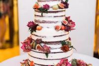 a lovely four tier naked wedding cake with bold blooms, fruits and berries will be a nice idea for a fall wedding with a farmhouse or other theme