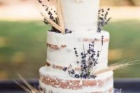 a lovely naked wedding cake with wheat and lavender looks cute and rustic