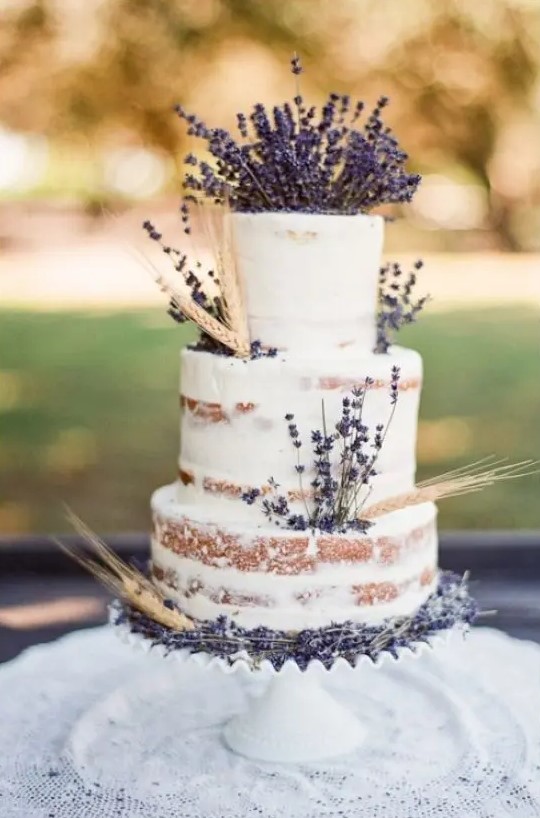 a lovely naked wedding cake with wheat and lavender looks cute and rustic