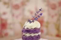 a mini naked lavender wedding cake with whipped cream and lavender on top for a summer wedding