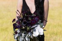 a moody Halloween wedding bouquet with deep purple, burgundy blooms, silver goliage and lotus is a jaw-dropping piece