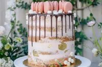 a naked cake with chocolate drip, meringues, pink macarons and gold leaf is a fresh and pretty idea for a cute spring wedding