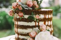 a naked wedidng cake with caramel drip, with pink and white blooms is amazing for summer or for spring