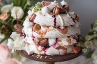 a pavlova wedding cake with berry compote, fresh peaches, nuts, blooms and meringues on top is amazing for a fall or summer wedding