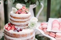 a pretty naked cake with fresh blooms, strawberries and cherries feels like summer