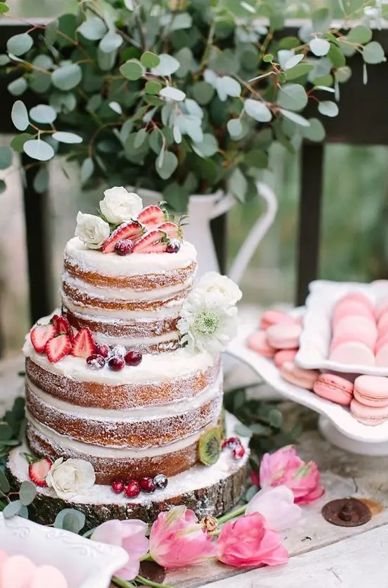 a pretty naked cake with fresh blooms, strawberries and cherries feels like summer