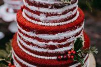 a red velvet Christmas wedding cake with berries, foliage and fir twigs is a pretty and cozy idea
