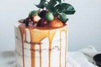 caramel drizzle semi naked wedding cake topped with citrus, cherries and fresh leaves for a summer wedding