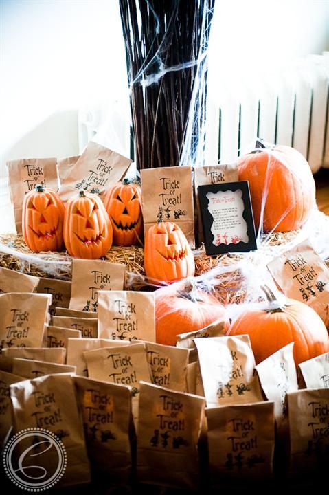 carved pumpkins and candies in paper bags are lovely Halloween wedding favors you can easily make