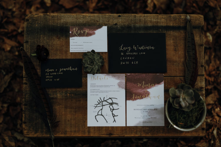 modern and moody wedding invitation suite in black and white, with calligraphy and burgundy watercolor