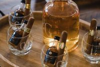personalized glasses with mini alcohol bottles and cigars are very cool to give to your groomsmen