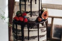 semi naked chocolate wedding cake with chocolate drip topped with fruit and berries is amazing for summer or fall