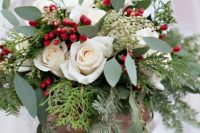 a beautiful Christmas wedding bouquet of greenery, fern, fir, white roses and berries is a timeless idea